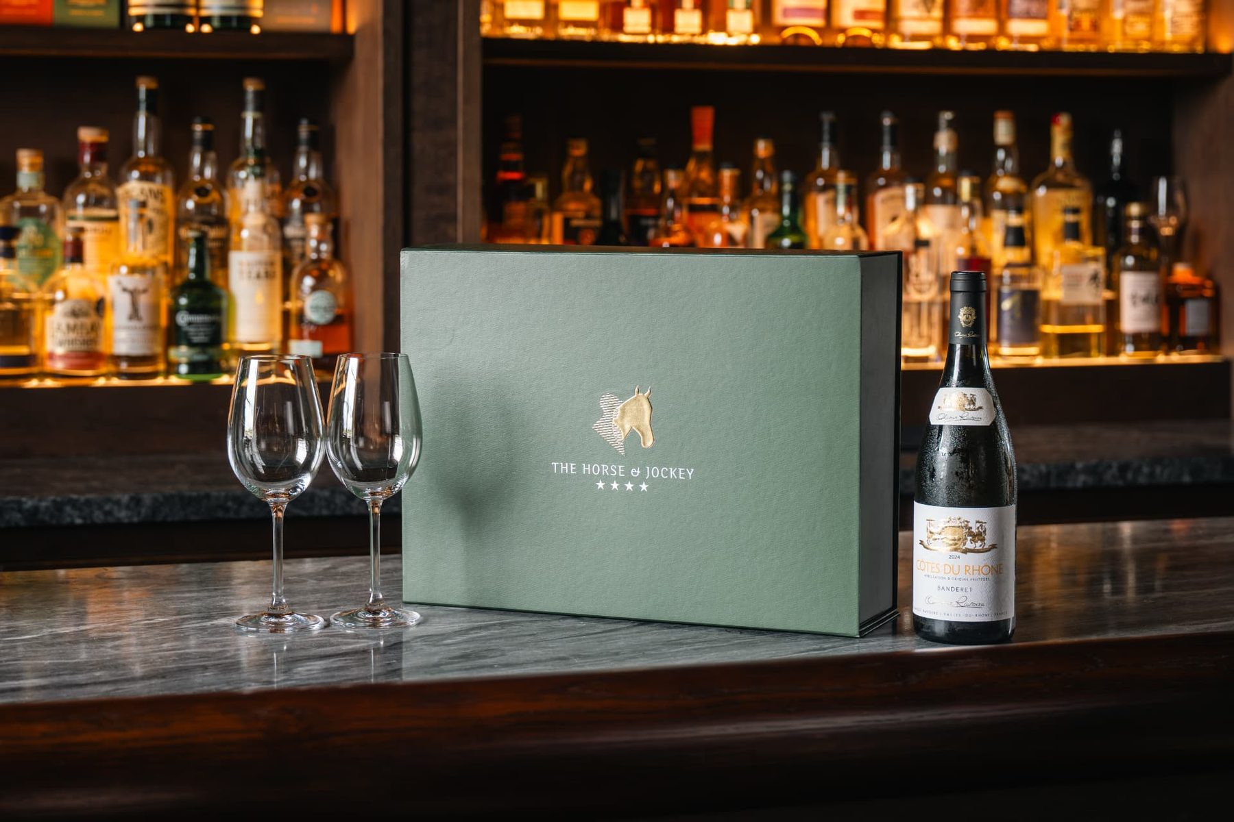 Sage green rigid gift box with a matt finish and gold foil logo featuring a horse head and "The Horse & Jockey" text.