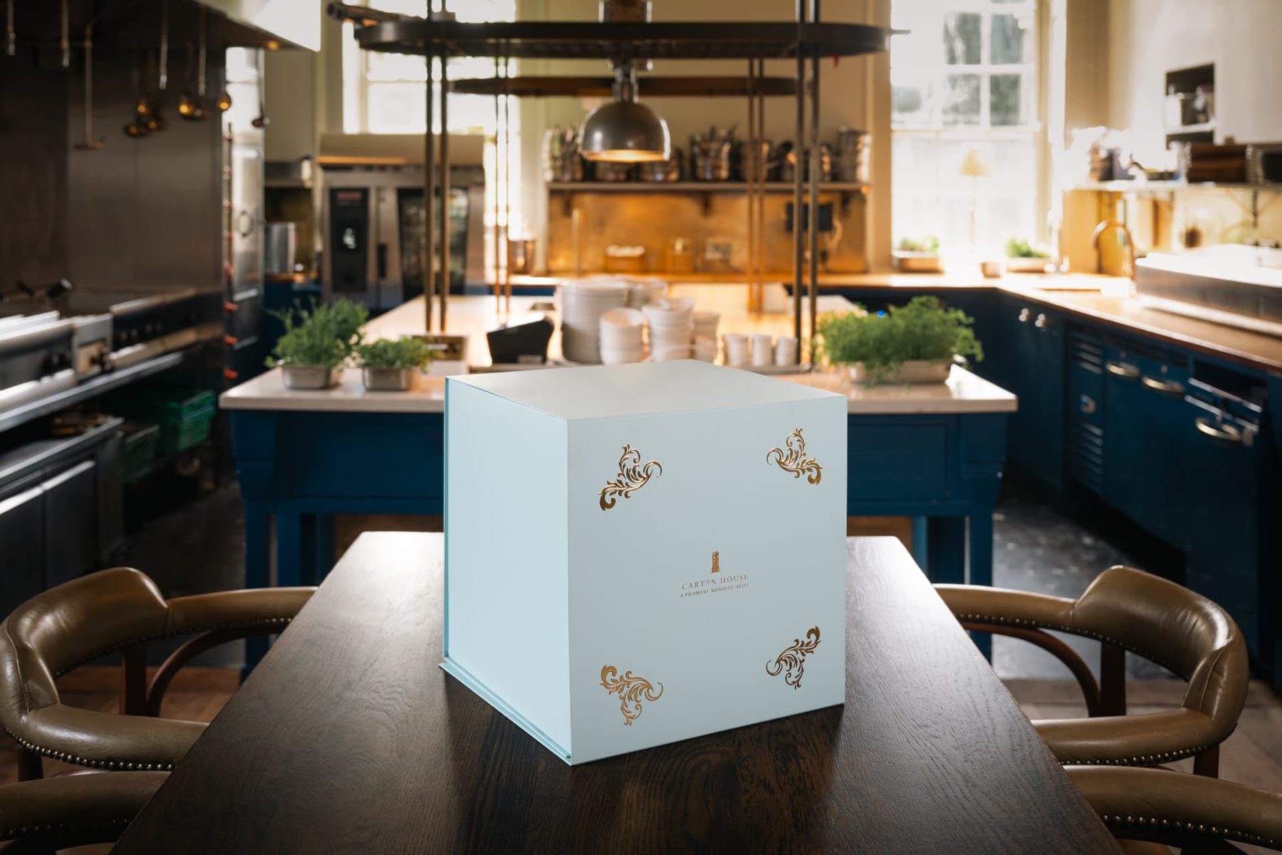 Duck egg blue rigid gift box with matt lamination and gold foil scrollwork. The box features a gold foil logo for Carton House.