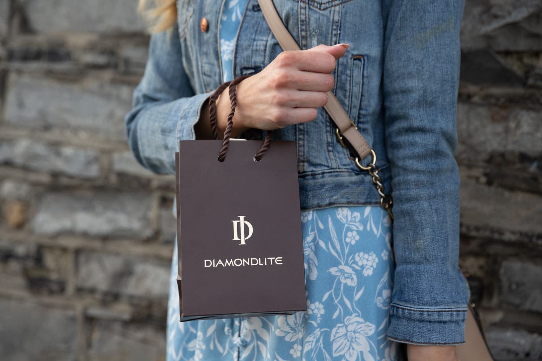 Small vertical brown paper bag with matt finish, white foil logo, and twisted brown rope handles, featuring the 'DIAMONDLITE' brand.