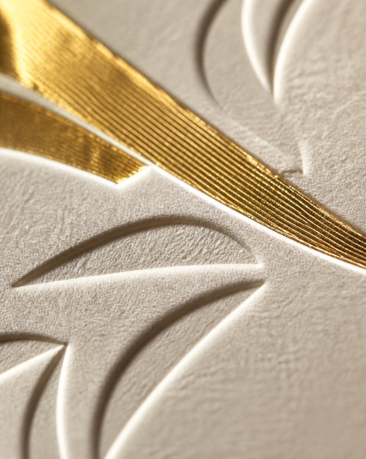 Gold hot foil and blind embossing on textured uncoated paper