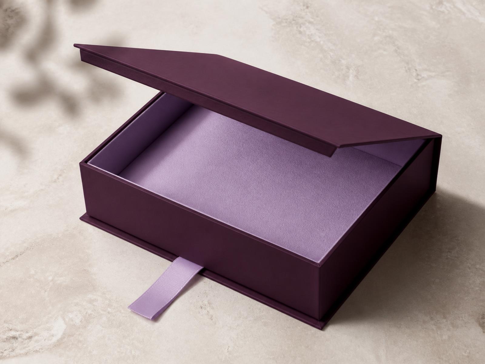 Deep plum rigid presentation box with lilac lining and ribbon pull
